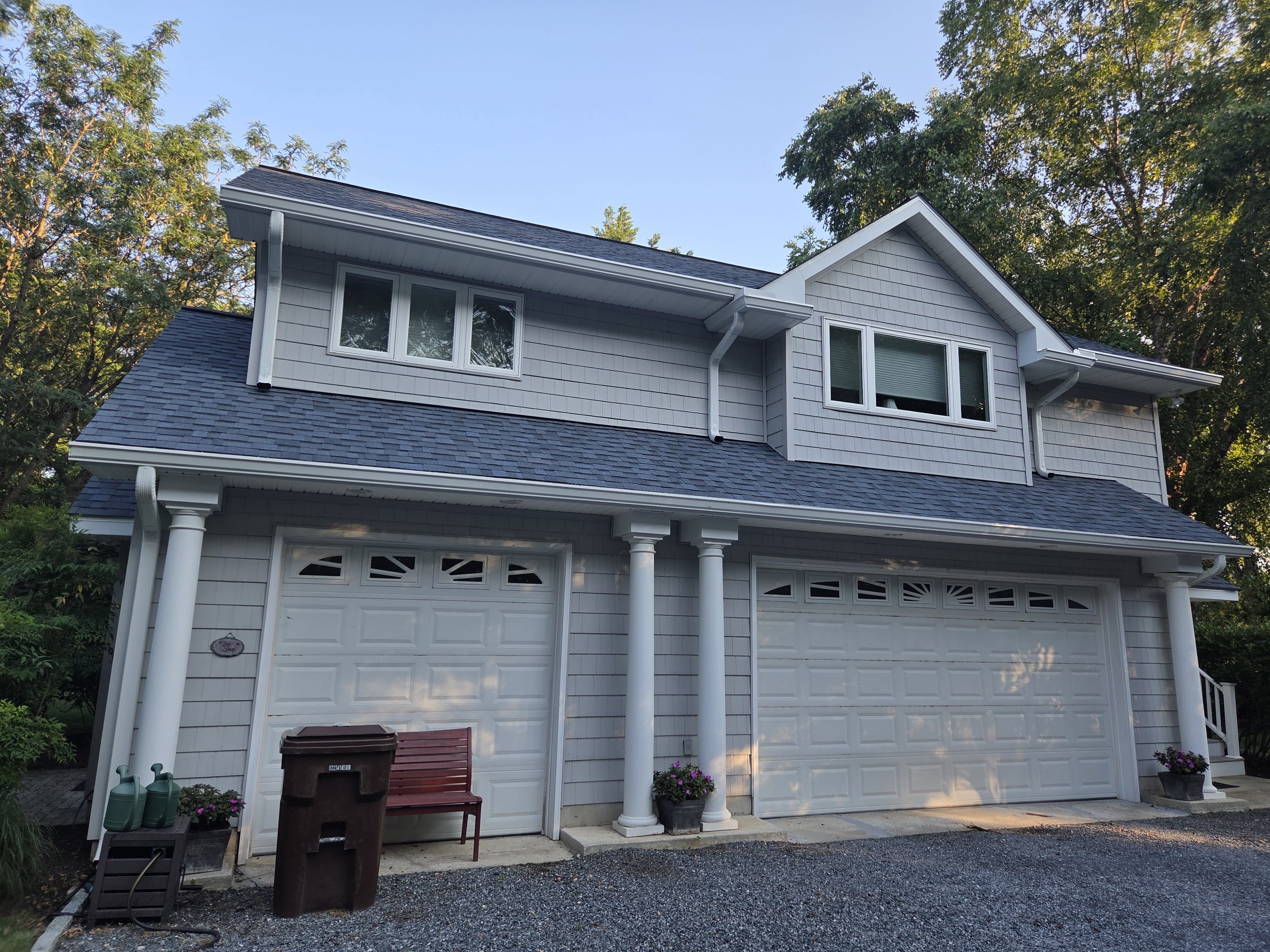 Closer view of a detached garage showing roofing detail, gutters, and clean finish work